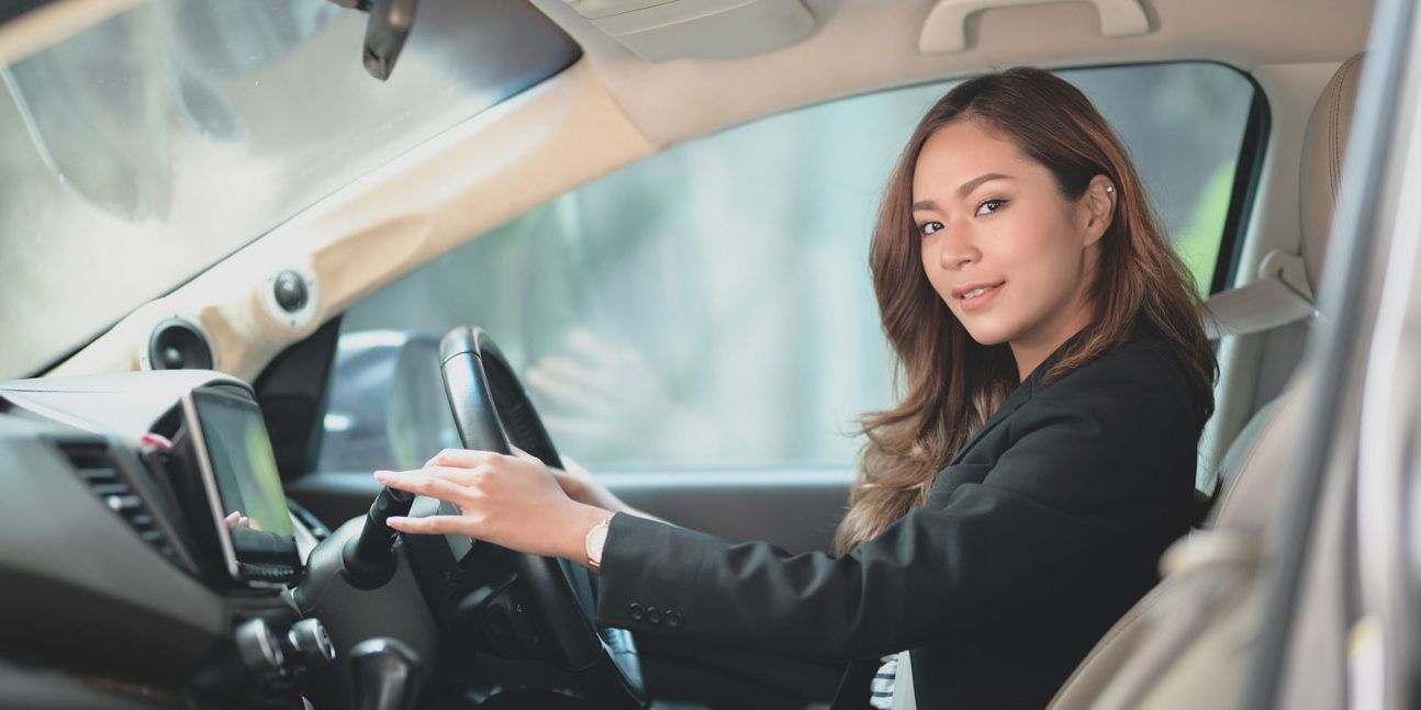 Professional Businesswoman Smiling While Driving the Car — Walnut, CA — Certified Safe Driver