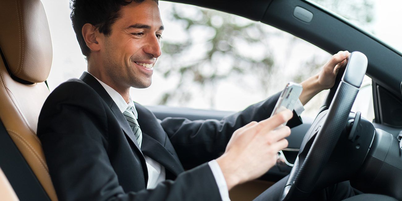 Businessmen Smiling at Phone — Walnut, CA — Certified Safe Driver