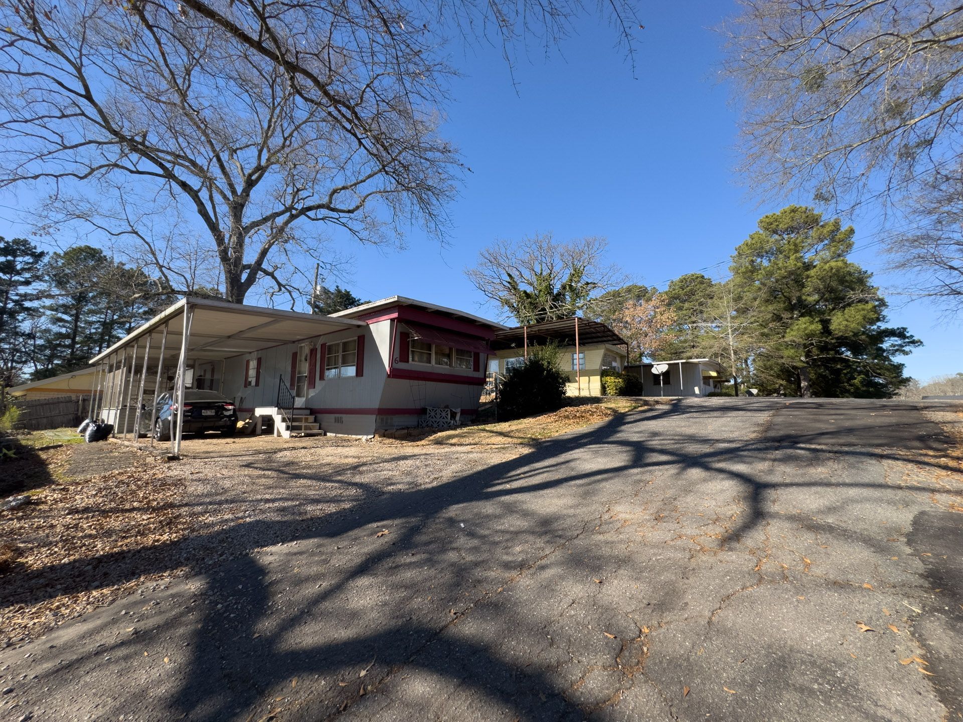 Road leading toward several houses on a sunny day.