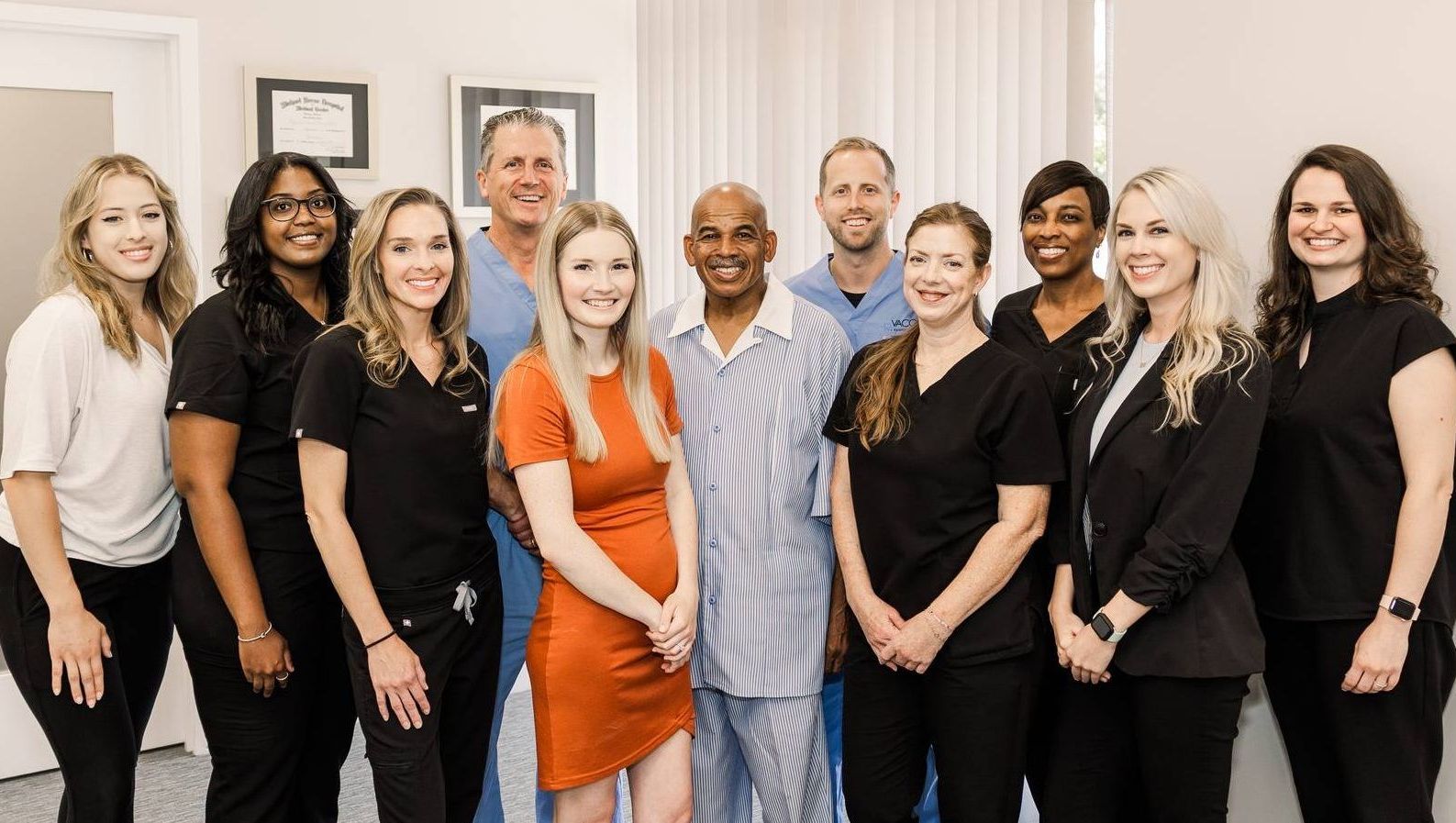 A group of people are posing for a picture together in a room.