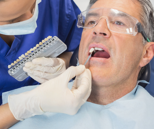 A man is getting his teeth examined by a dentist