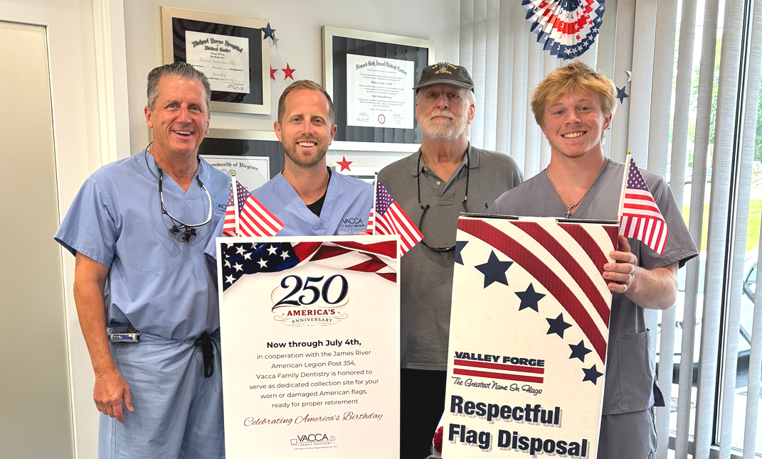 Four men in work uniforms hold patriotic posters at an indoor event.