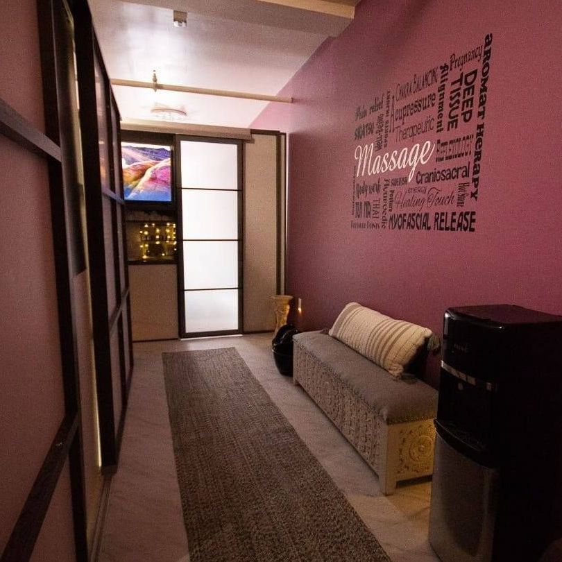 A hallway with a sign on the wall that says massage