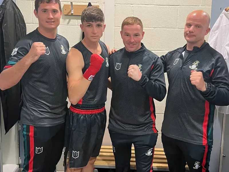 A group of men are posing for a picture in a locker room.