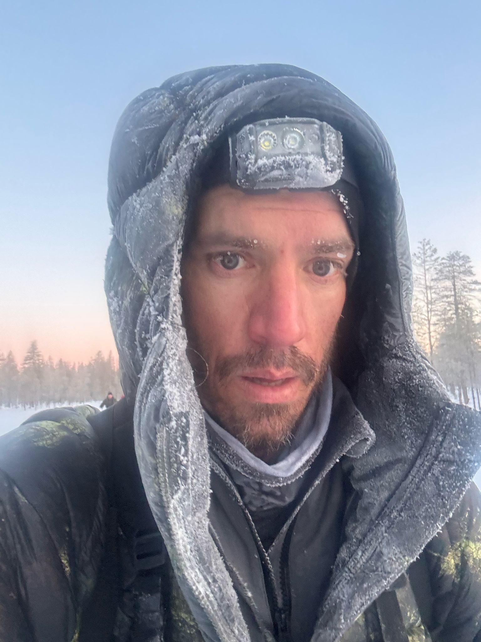 A man in a military uniform shakes hands with queen elizabeth
