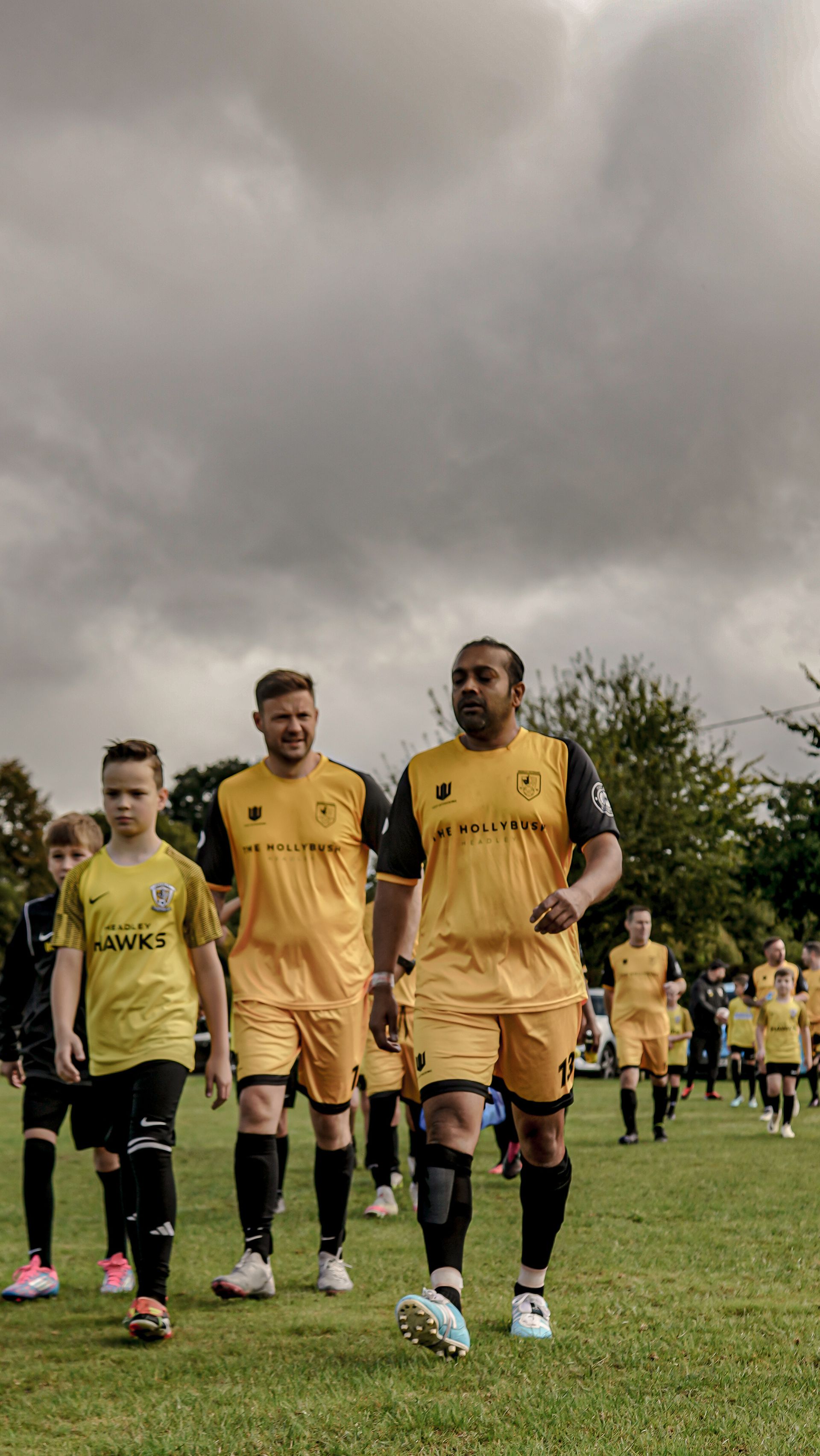A group of soccer players are walking on a field.