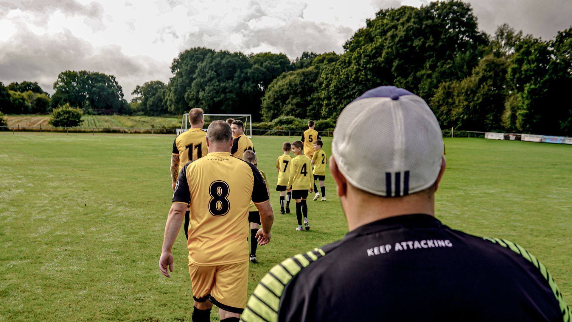 A group of soccer players are walking on a field.