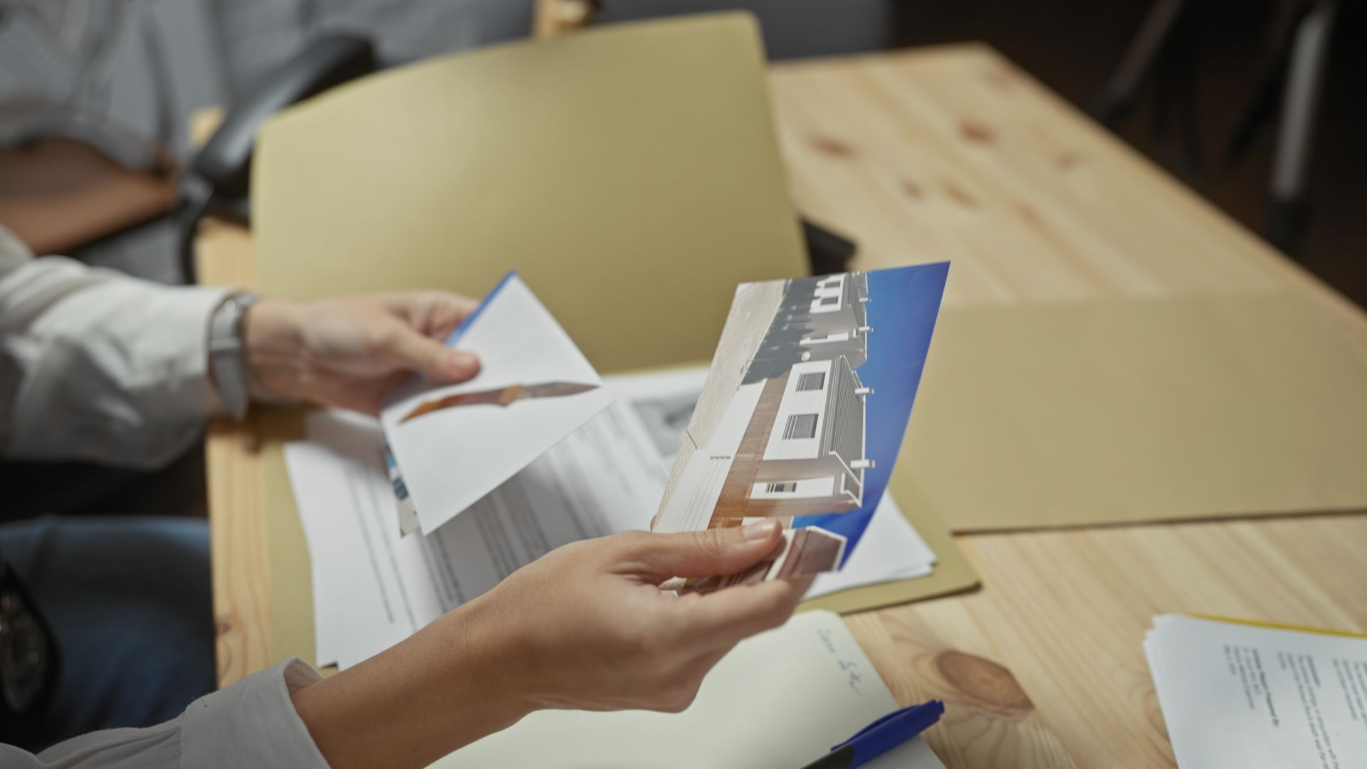 A person is holding a piece of paper in their hands.