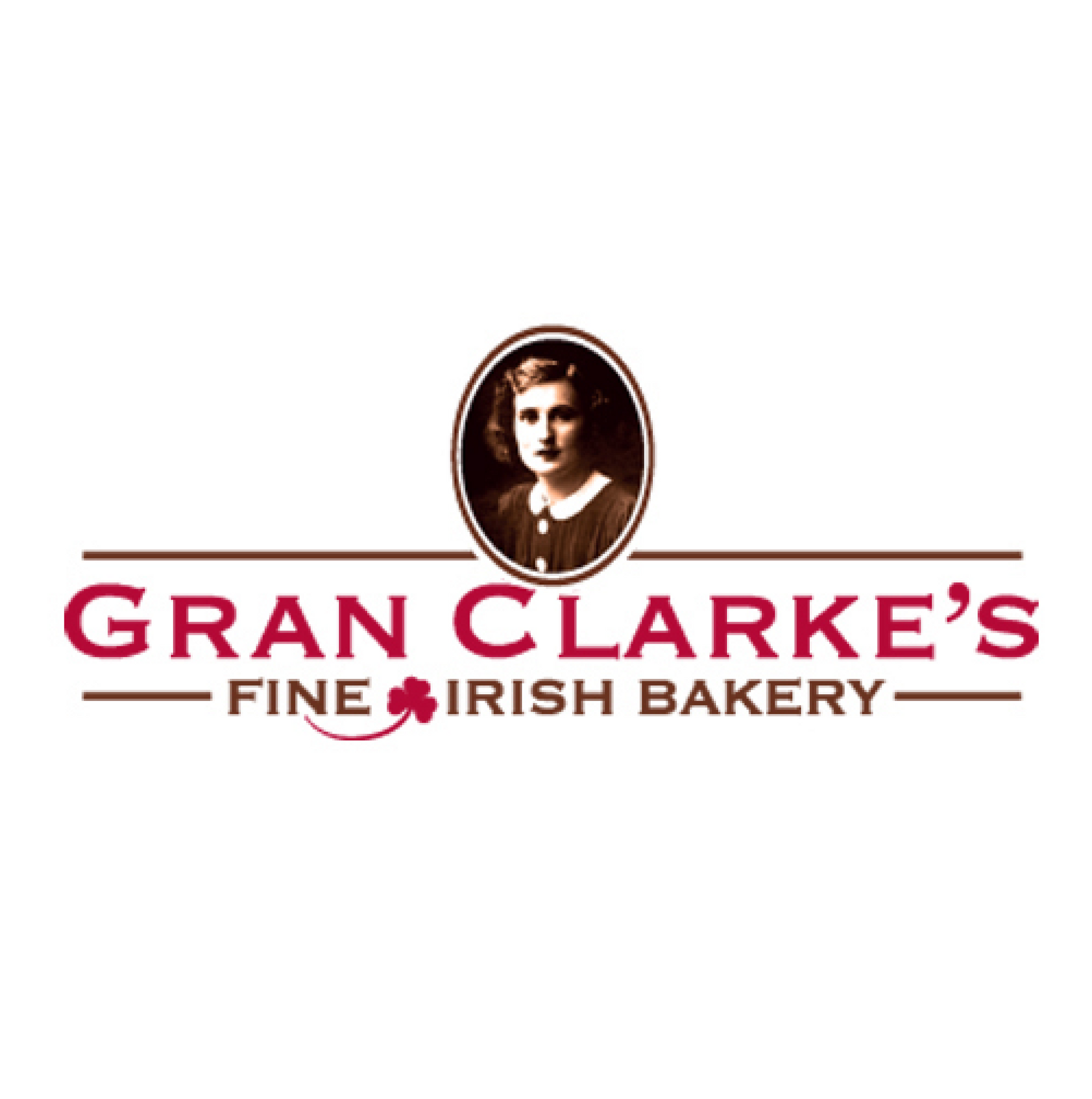 Gran Clarke's Fine Irish Bakery logo. Oval portrait, woman in maroon text below, with shamrock.