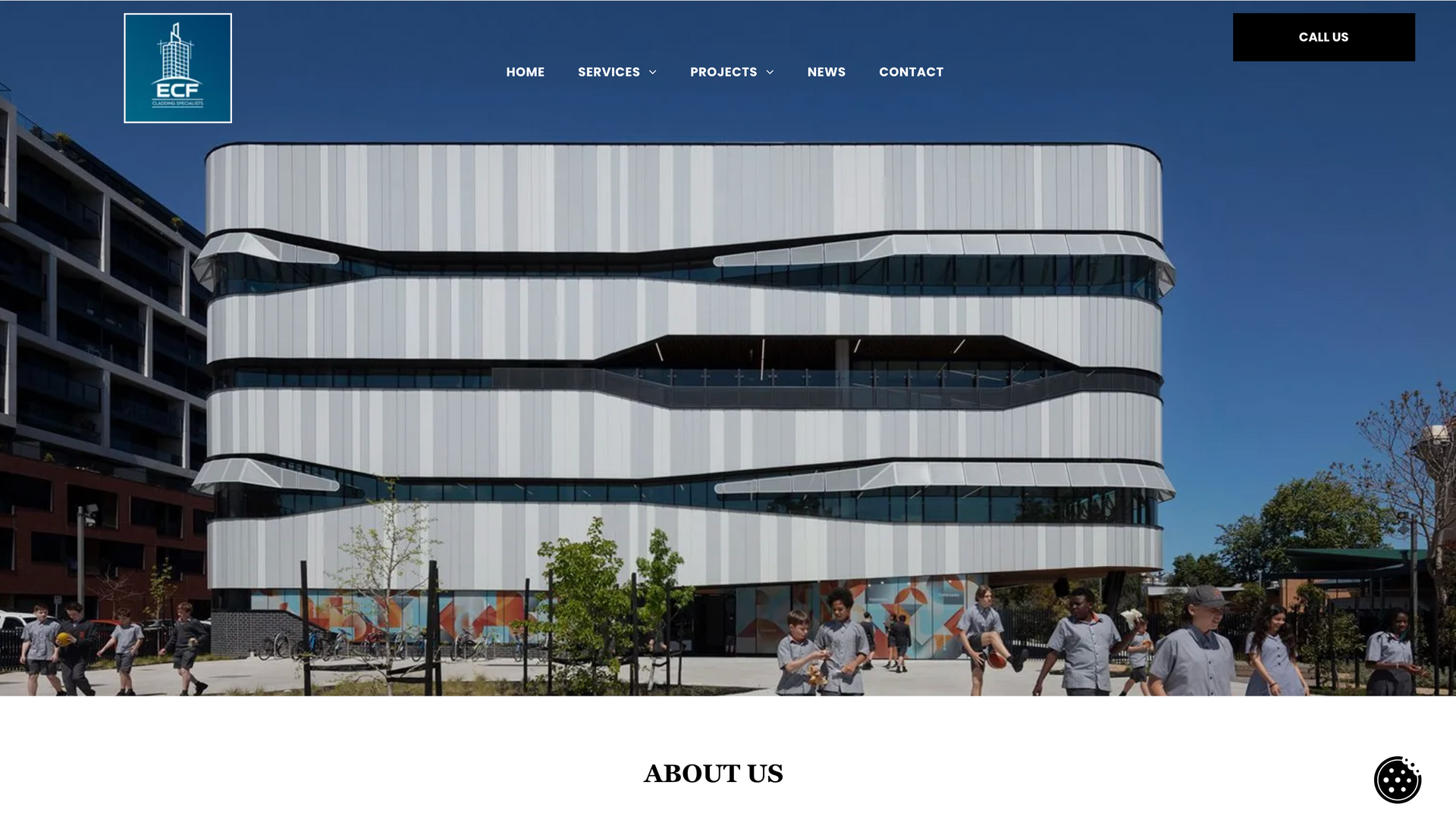 Modern building with curved facade; students outside.