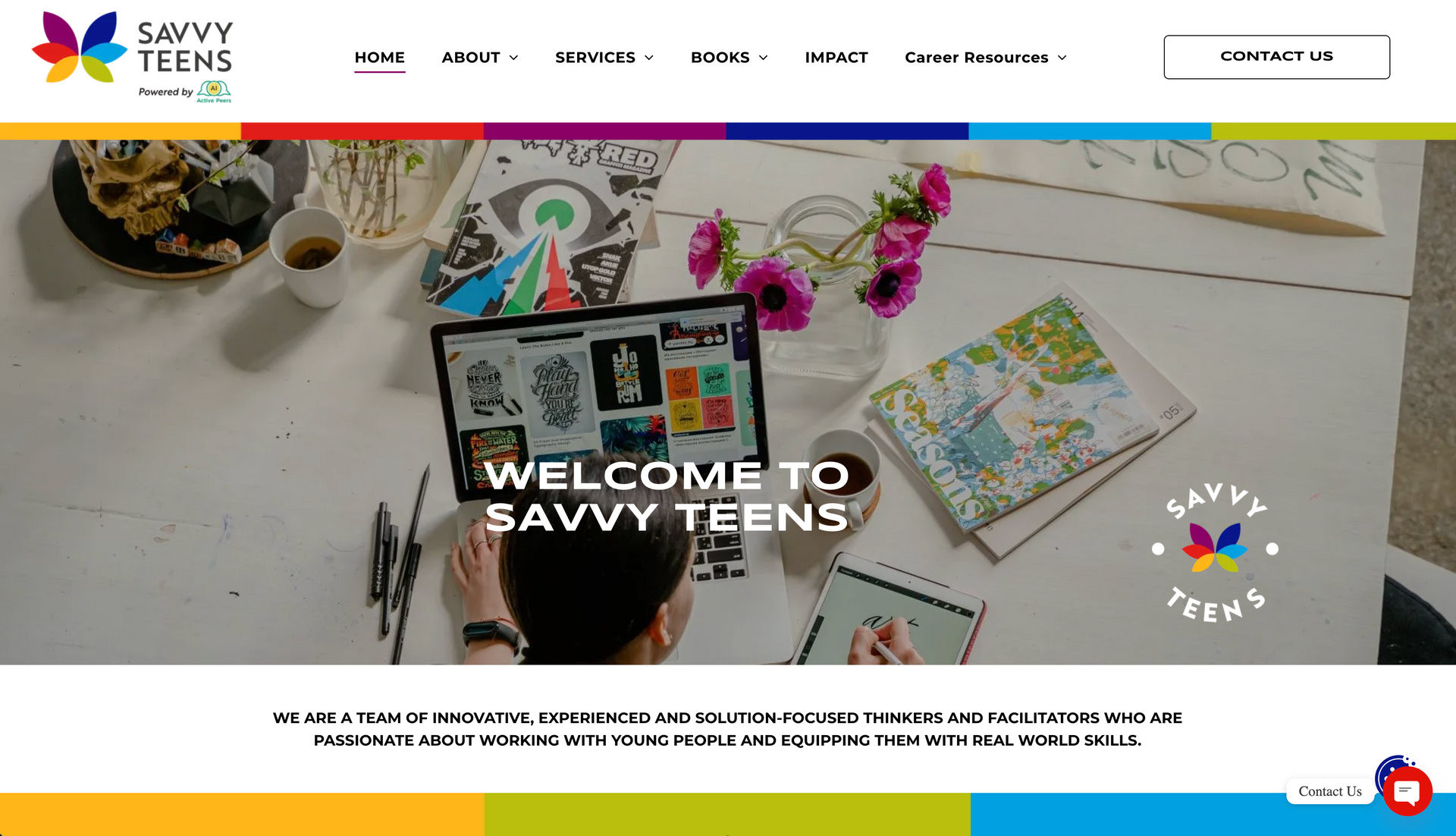 Savvy Teens website homepage with a laptop and artistic materials on a white table.