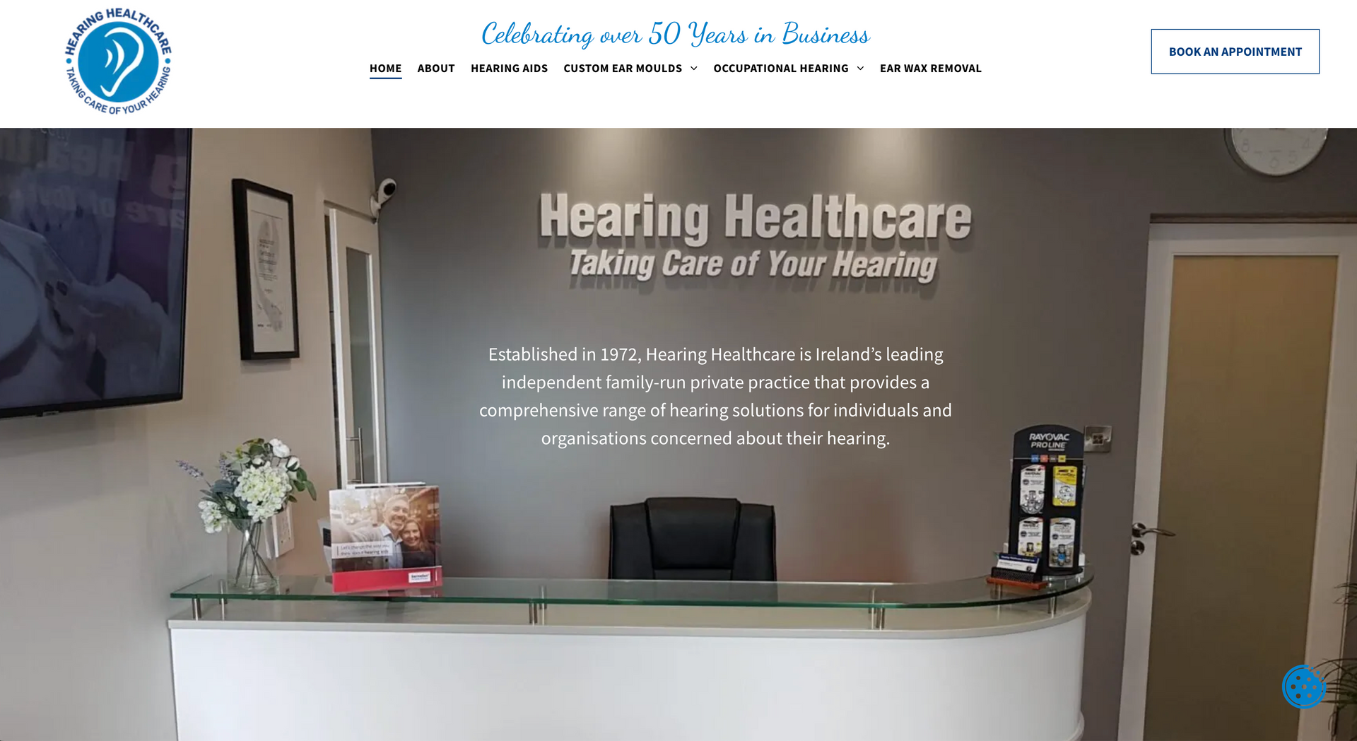 Reception area of Hearing Healthcare, with reception desk and signage.