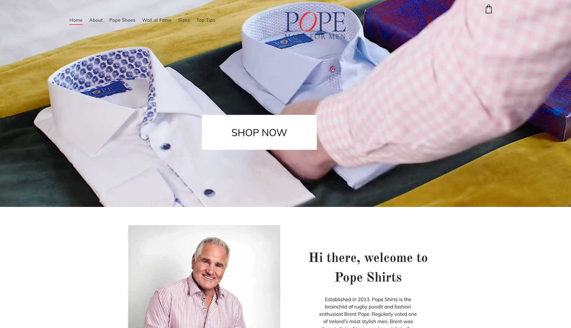 Man arranging dress shirts on a table; 