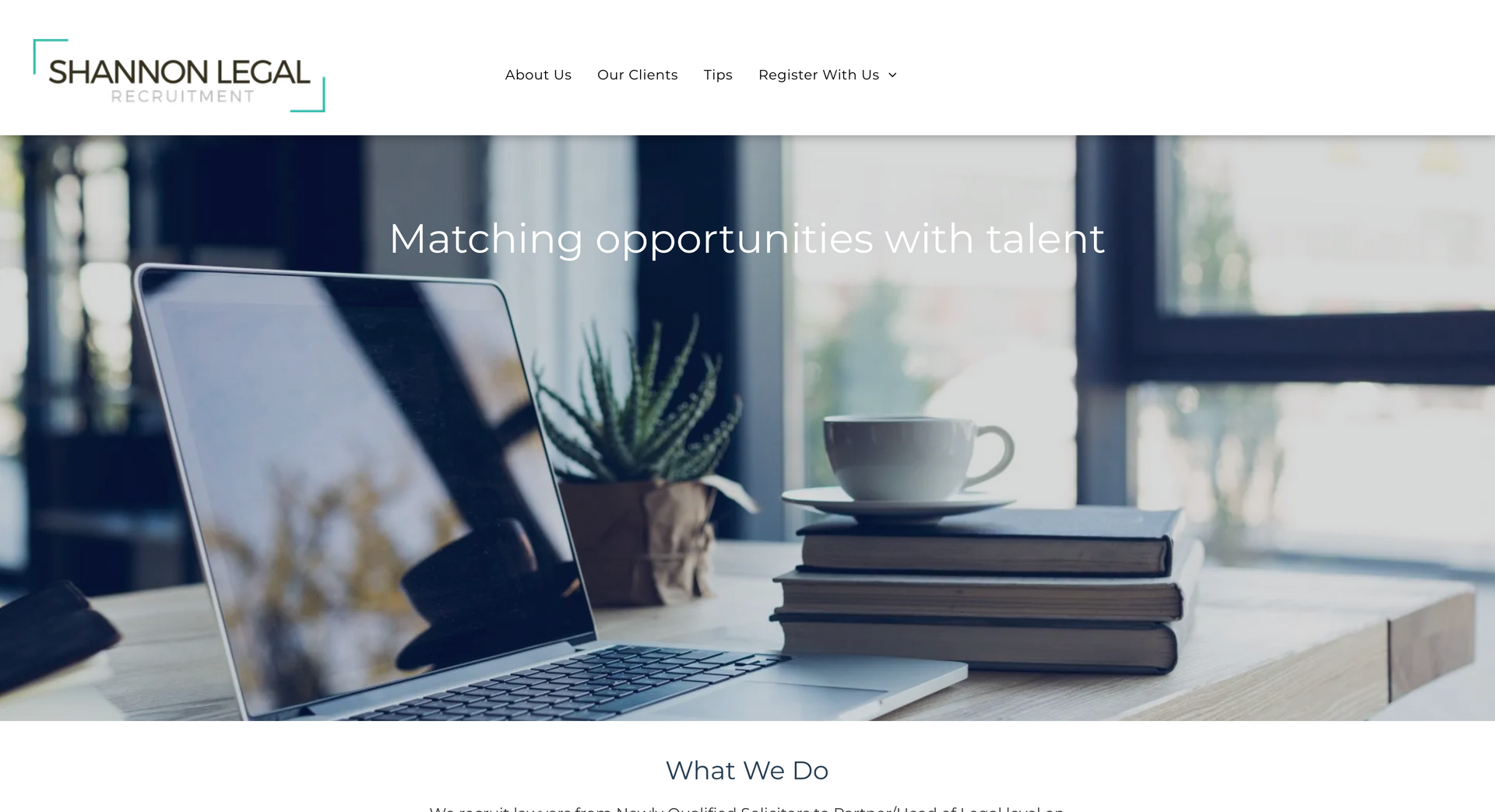 Laptop and books with a coffee cup on a desk. Matching opportunities with talent.