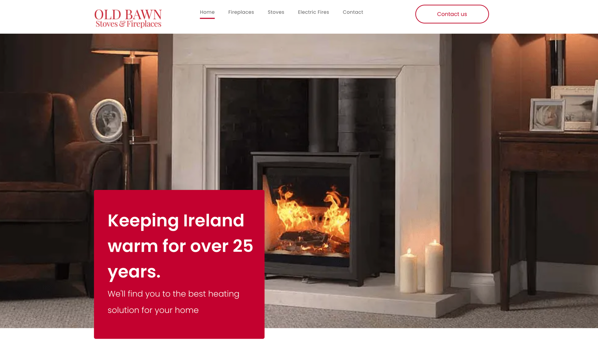 Fireplace with lit fire in a living room, candles, text 