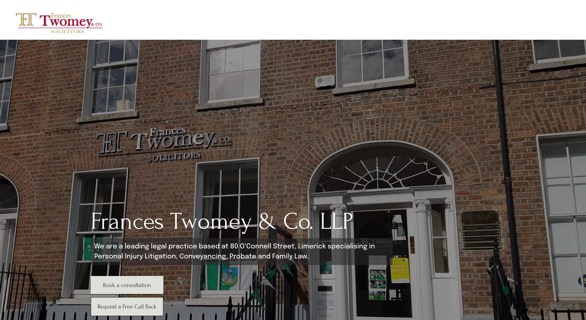 Exterior of Frances Twomey & Co. building. Brick facade, windows, and entrance with a sign, 