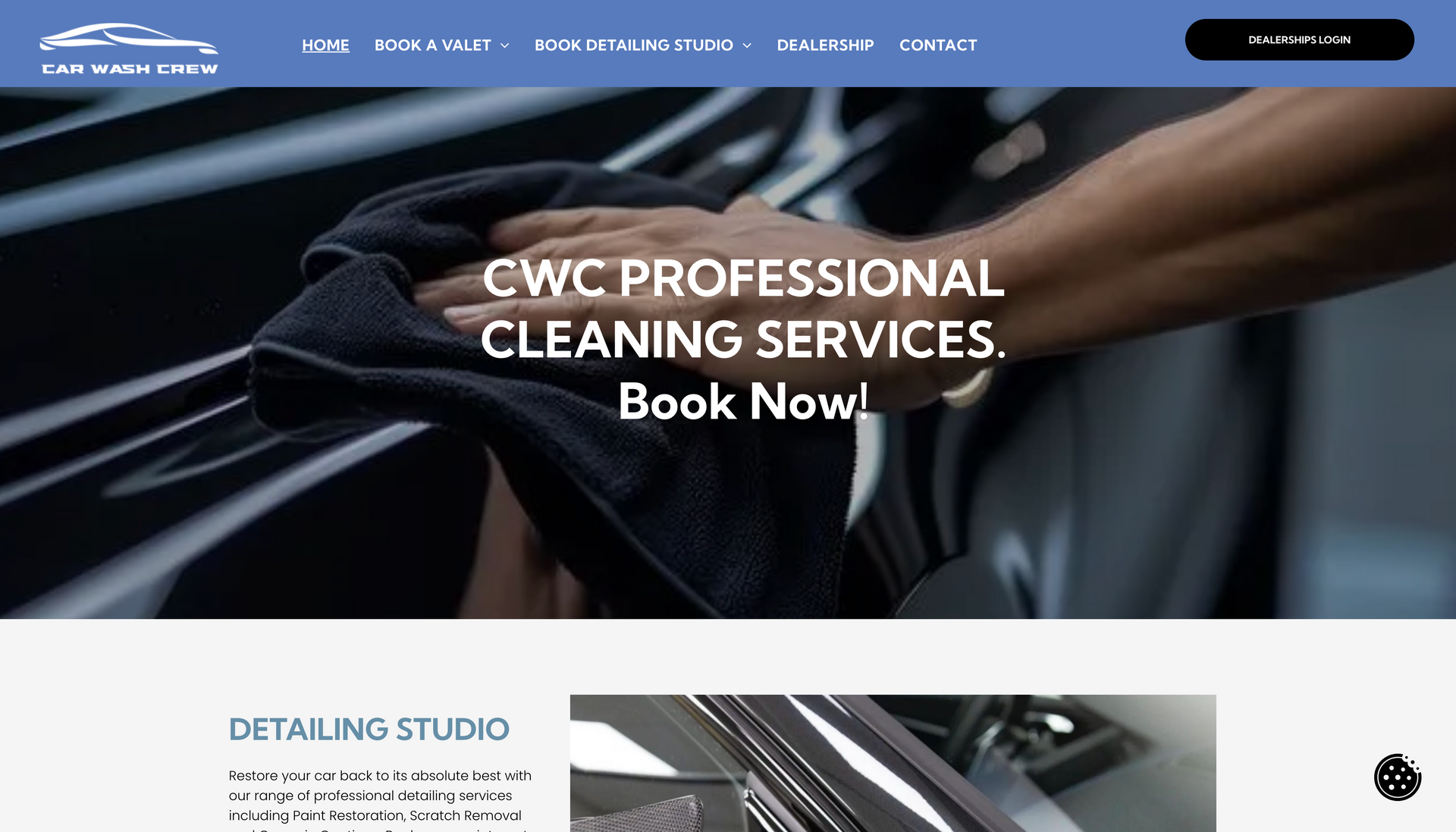 Man wiping down a car with a black cloth. 