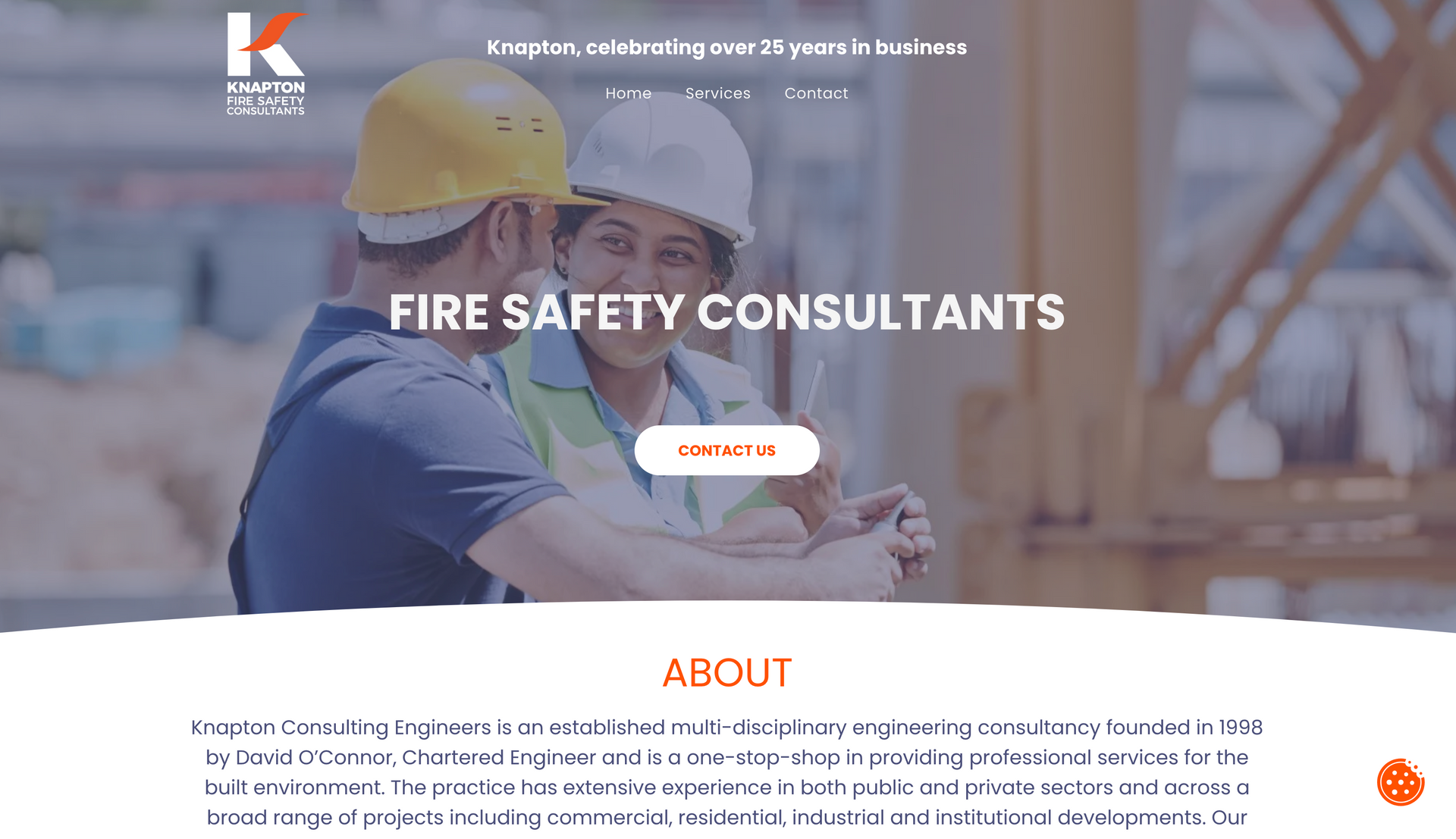 Two fire safety consultants in hard hats on a construction site.