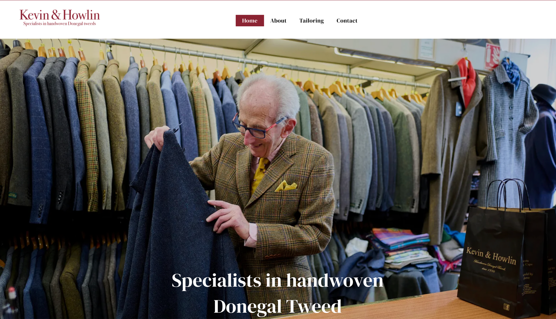 Man examining tweed coat in a shop, rows of tweed jackets visible.