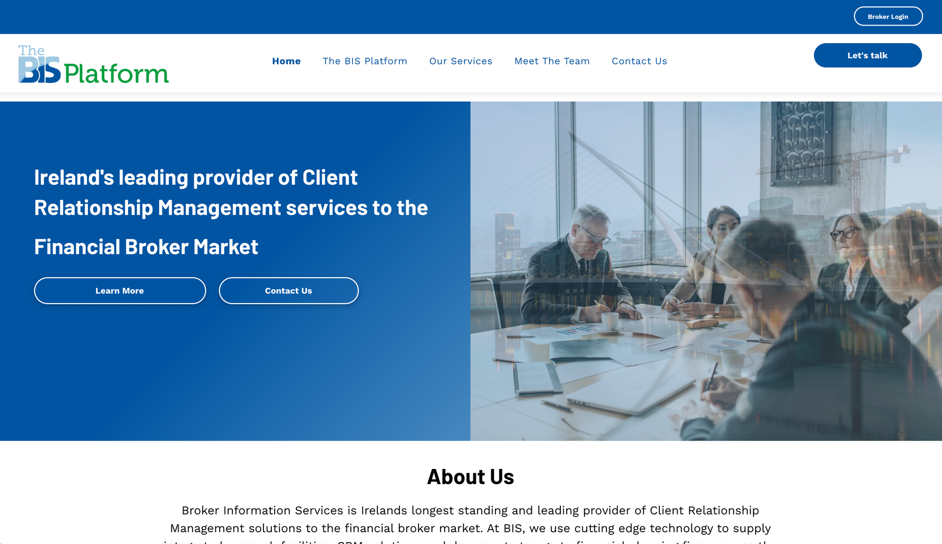 Website homepage with blue and white color scheme, featuring text and a business meeting photo.
