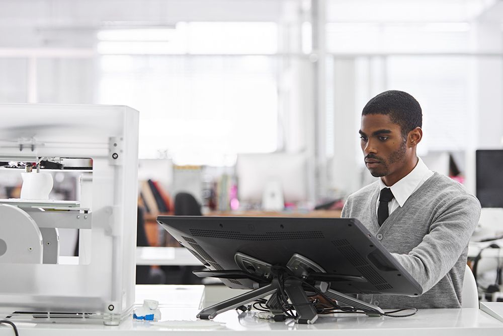 a man working on a laptop in an office