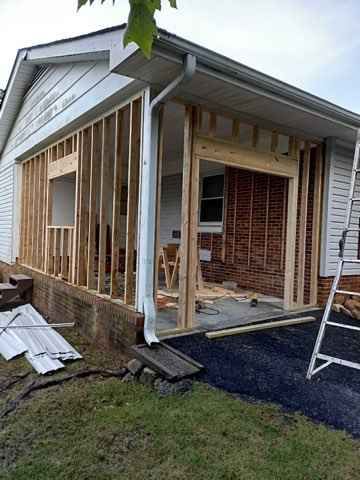 A house is being remodeled with a porch and a window.