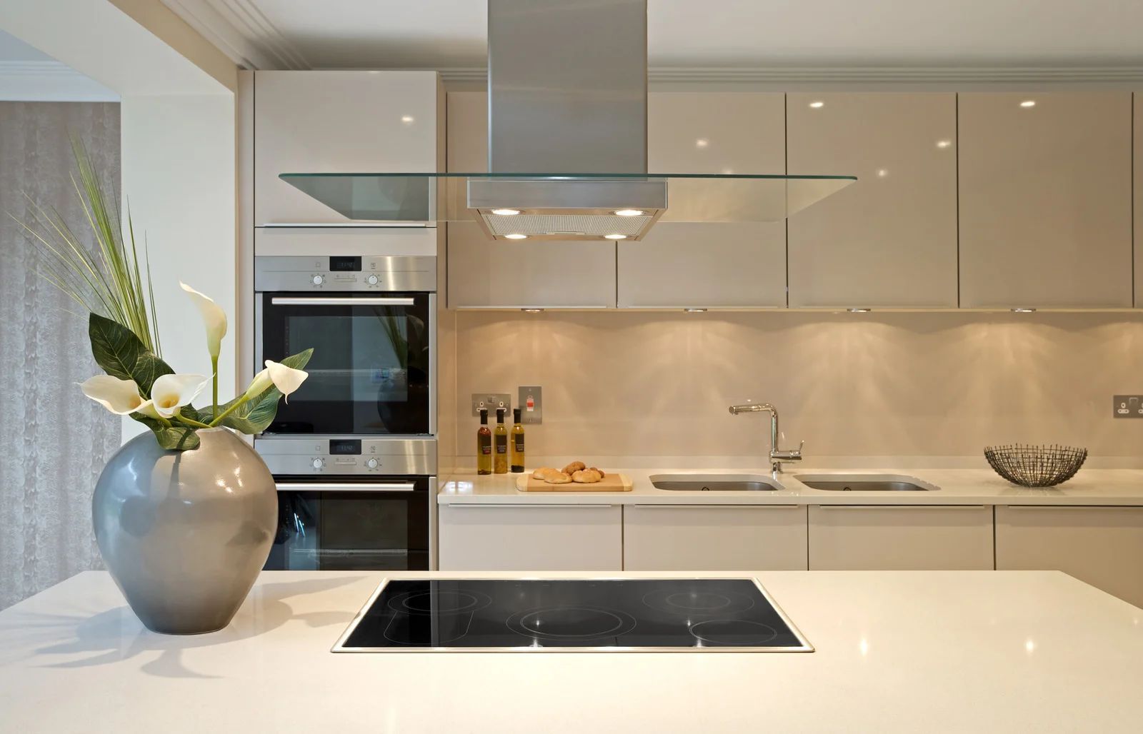 A kitchen with white cabinets and a stove top oven