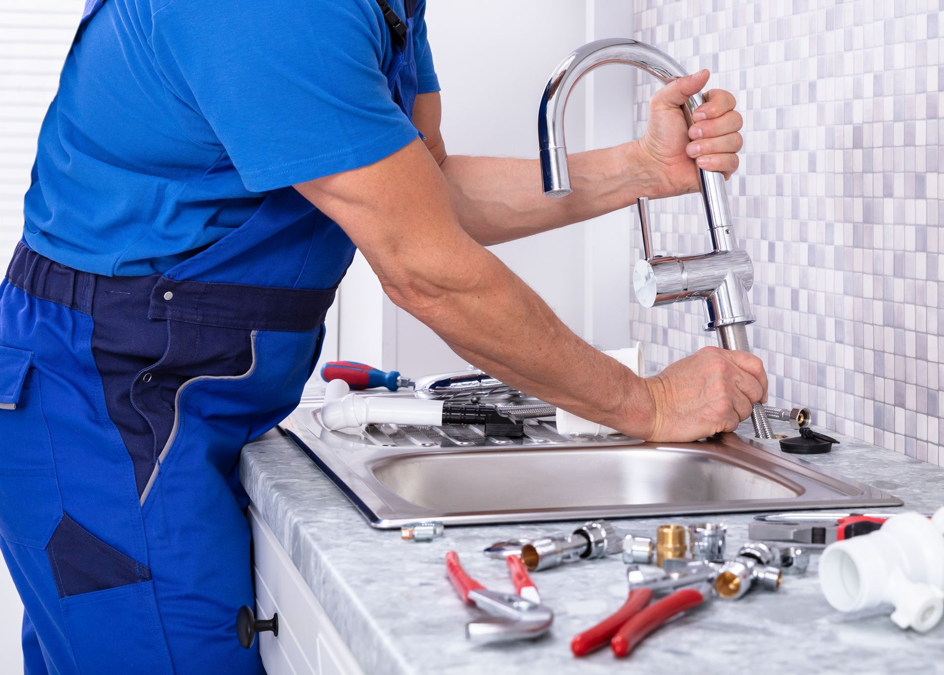Professional Plumber Fixing Faucet