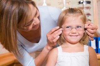 Eyeglasses on young girl at optometrists - Eye Care Center in Holicong, PA