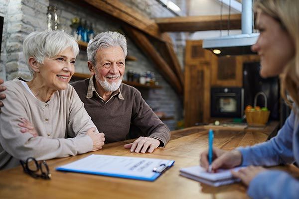 Happy Senior Couple Talking to Insurance Agent — Willits, CA — Cantua Insurance