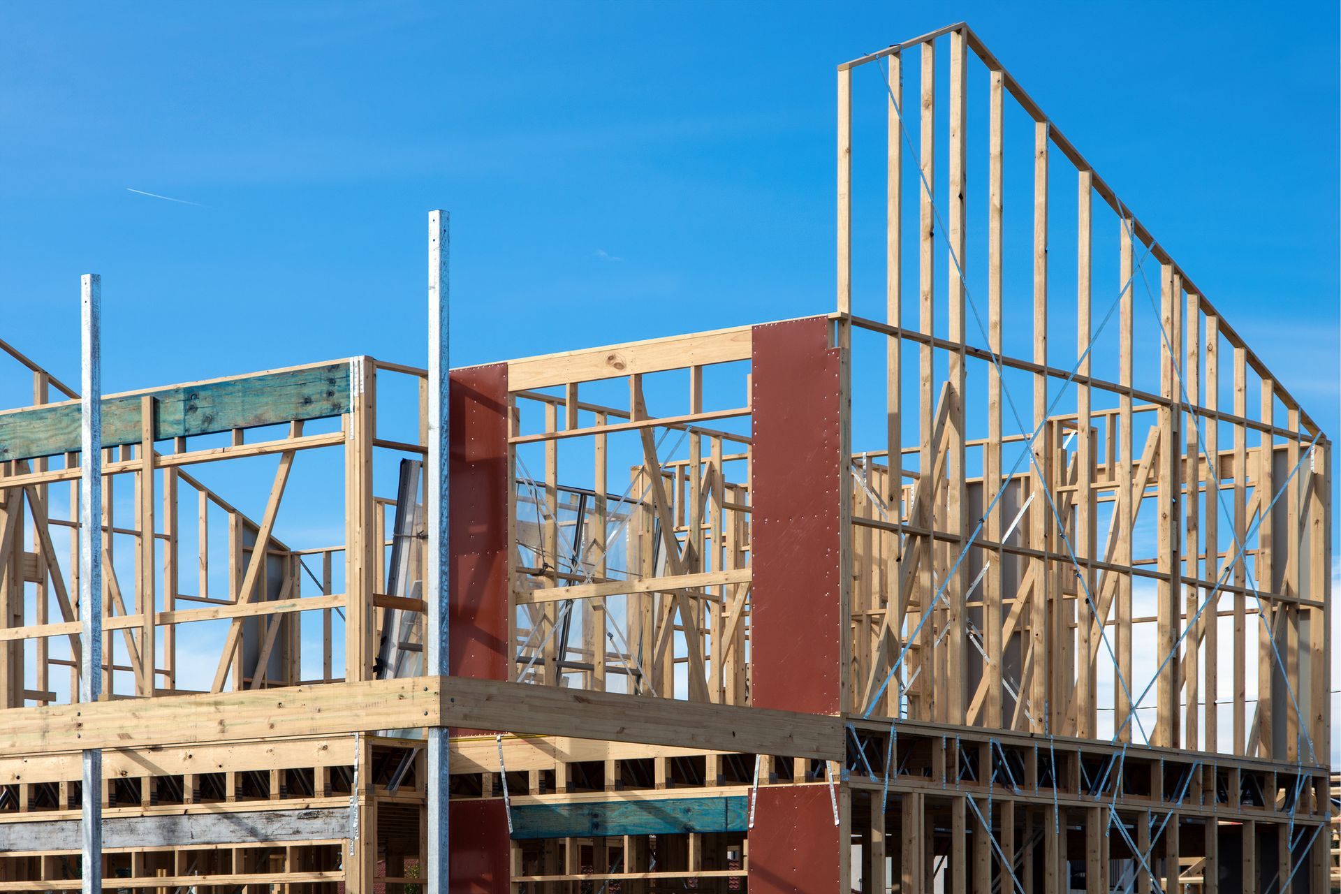 A building under construction with a blue sky in the background
