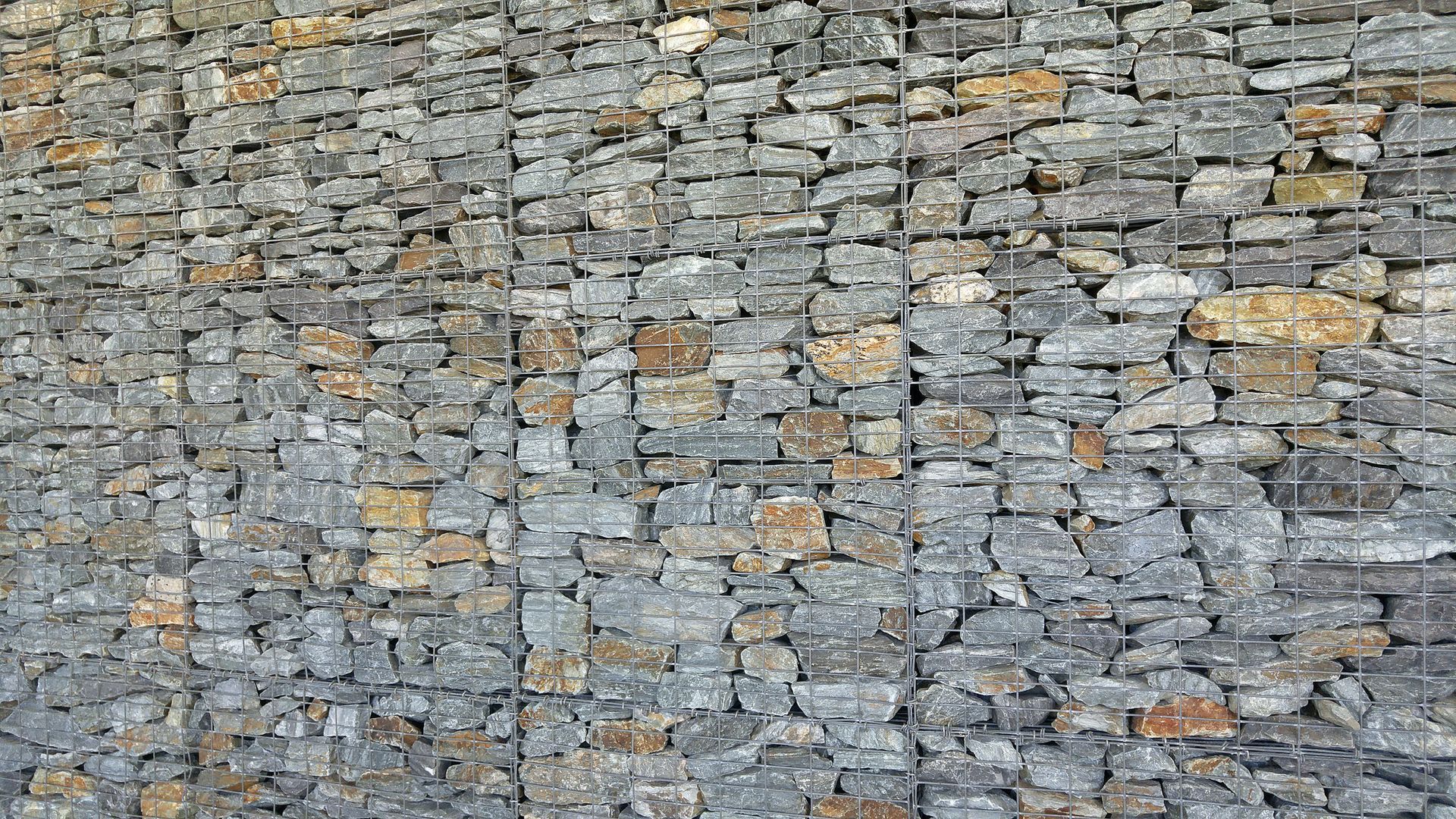 A close up of a stone wall with a lot of rocks.