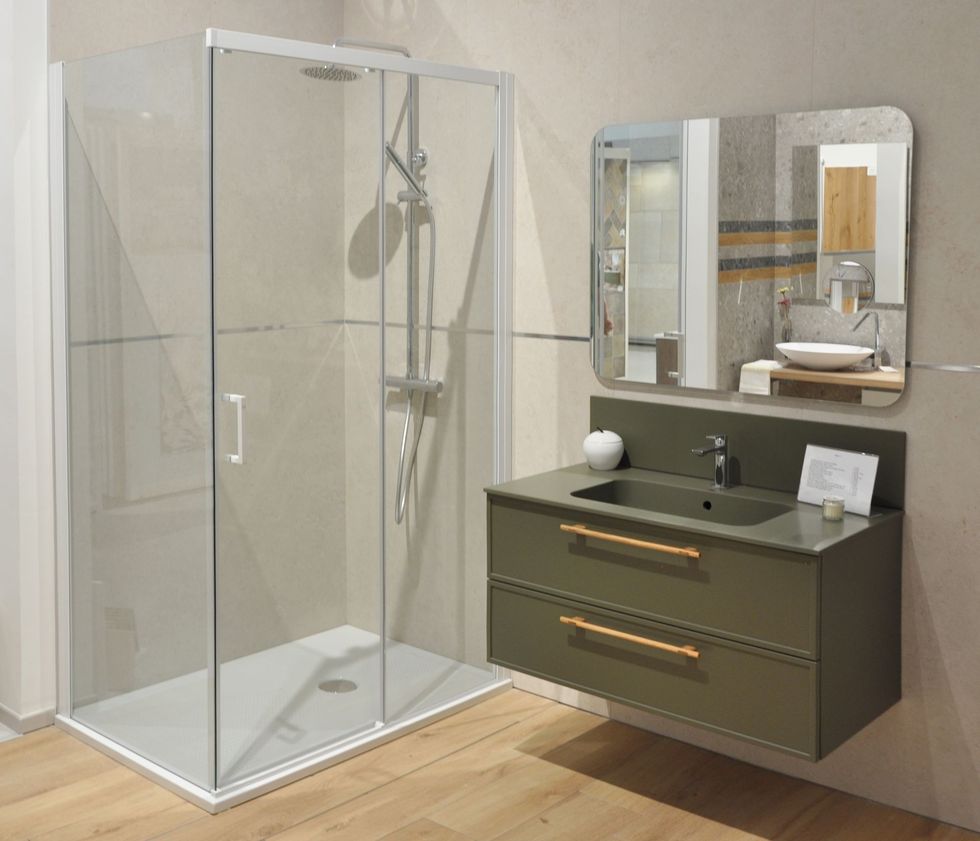 Un bagno con lavandino, doccia e specchio