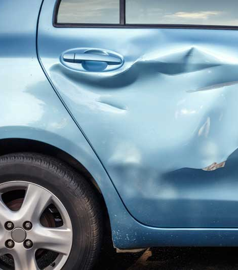 Blue Car in Need of Auto Body Repair