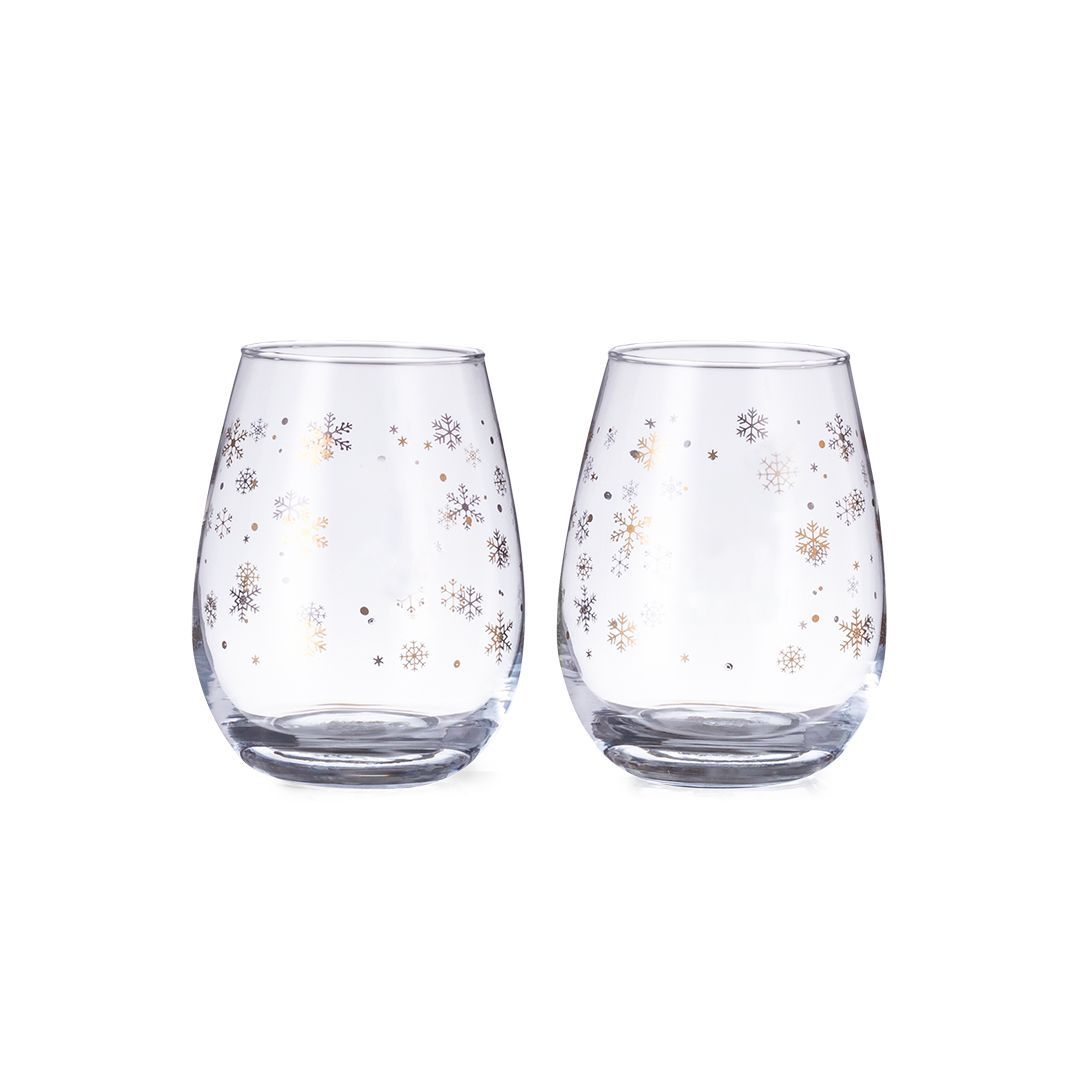 Dos copas de vino transparentes sin tallo, una al lado de la otra, cada una decorada con delicados motivos de copos de nieve en tono dorado.