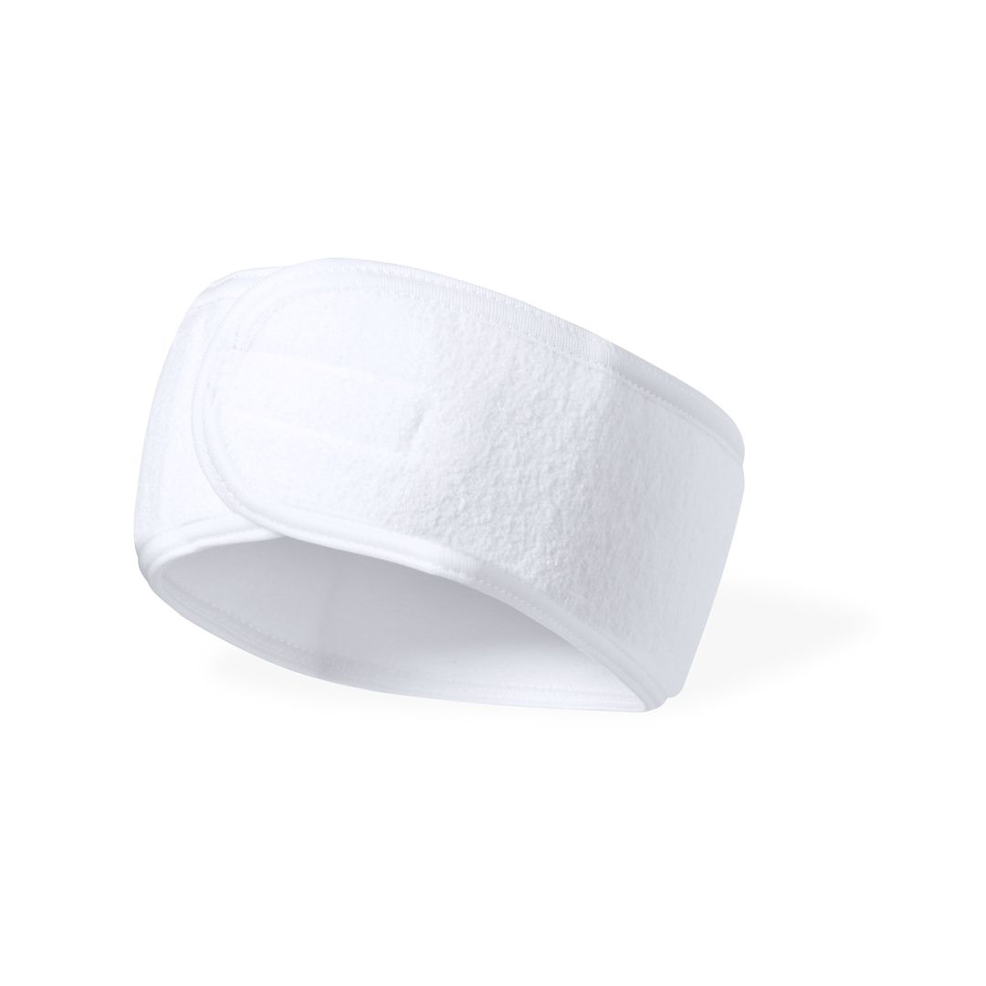 Una diadema blanca de tela ajustable con cierre de velcro, que se usa comúnmente para sujetar el cabello durante los tratamientos faciales.