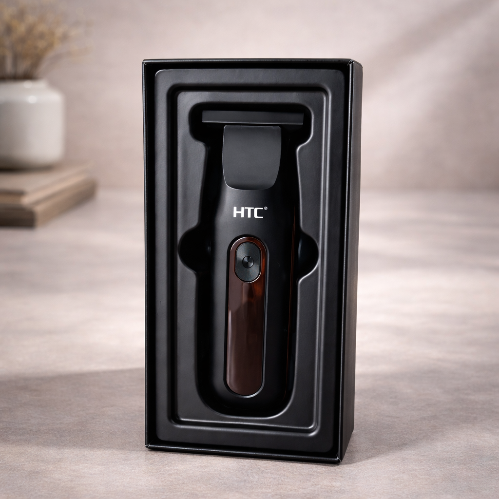 Una recortadora de pelo eléctrica HTC negra descansa dentro de una bandeja de almacenamiento de plástico negro sobre una superficie de color neutro.