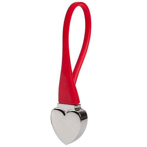 Un colgante de metal plateado con forma de corazón, sujeto a una argolla de silicona roja y flexible.