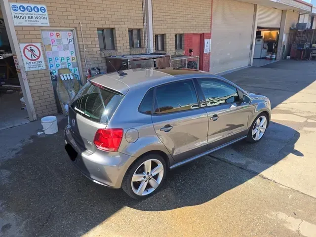 A grey VW is parked in front of a car dealership — Southside Bodyworks in Greenway, ACT