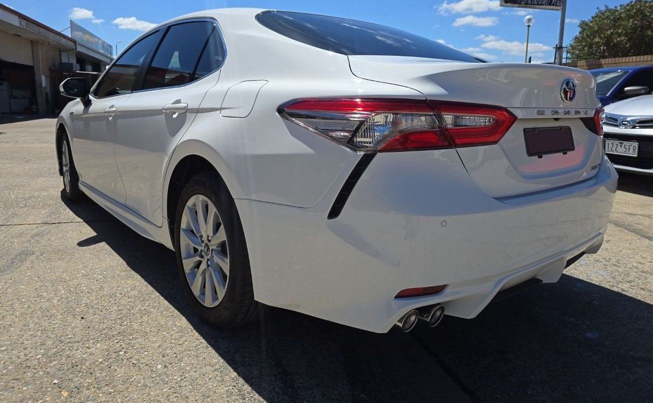 A white Toyota Camry is parked in a parking lot — Southside Bodyworks in Greenway, ACT