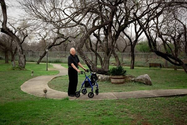 Old man walking with a support
