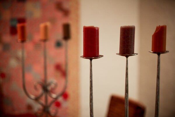 View of scented candles mounted on a candle stand