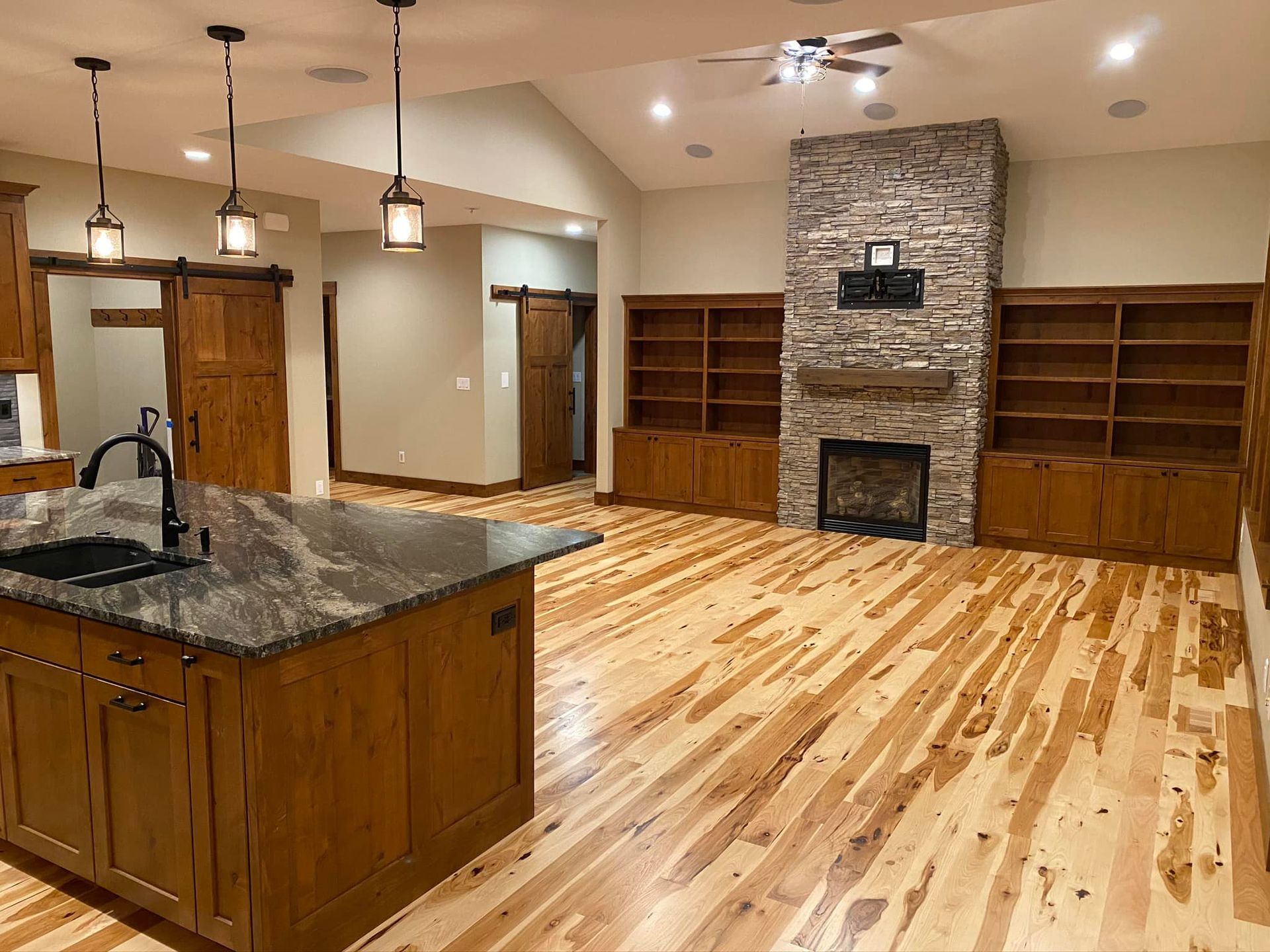 There is a large island in the middle of the room with a fireplace.