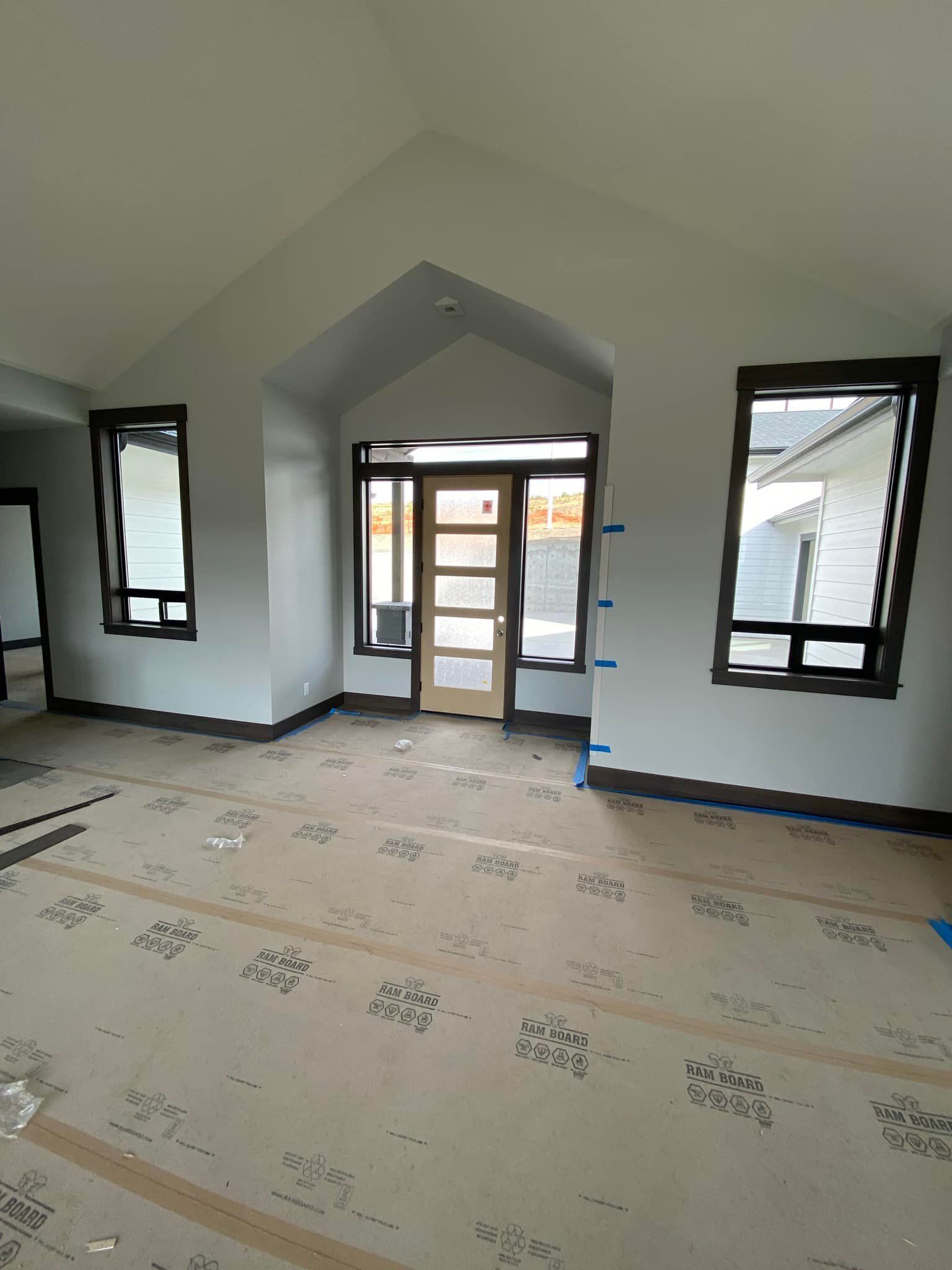 An empty room with a lot of windows and a door