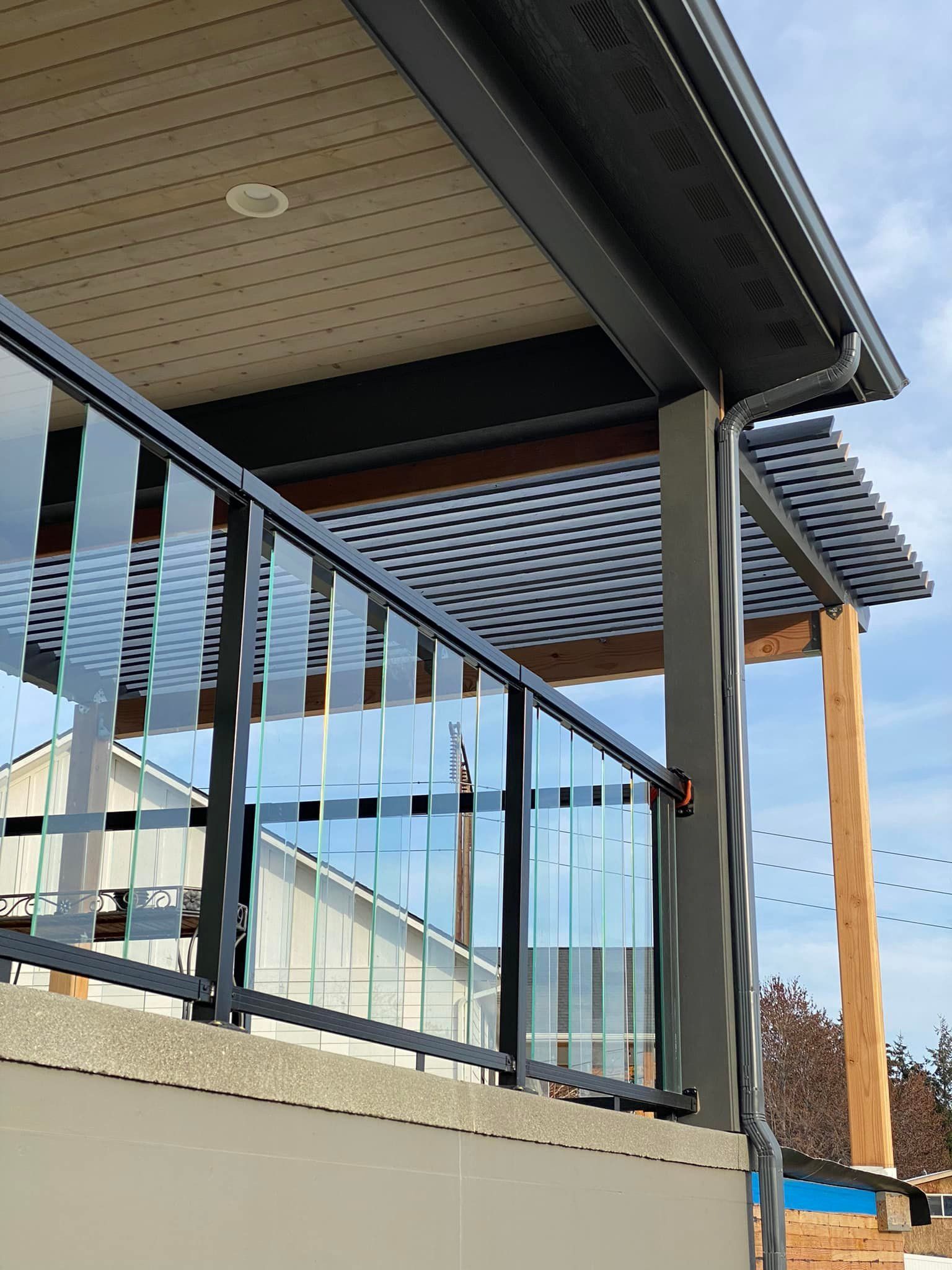 A balcony with a glass railing and a canopy over it