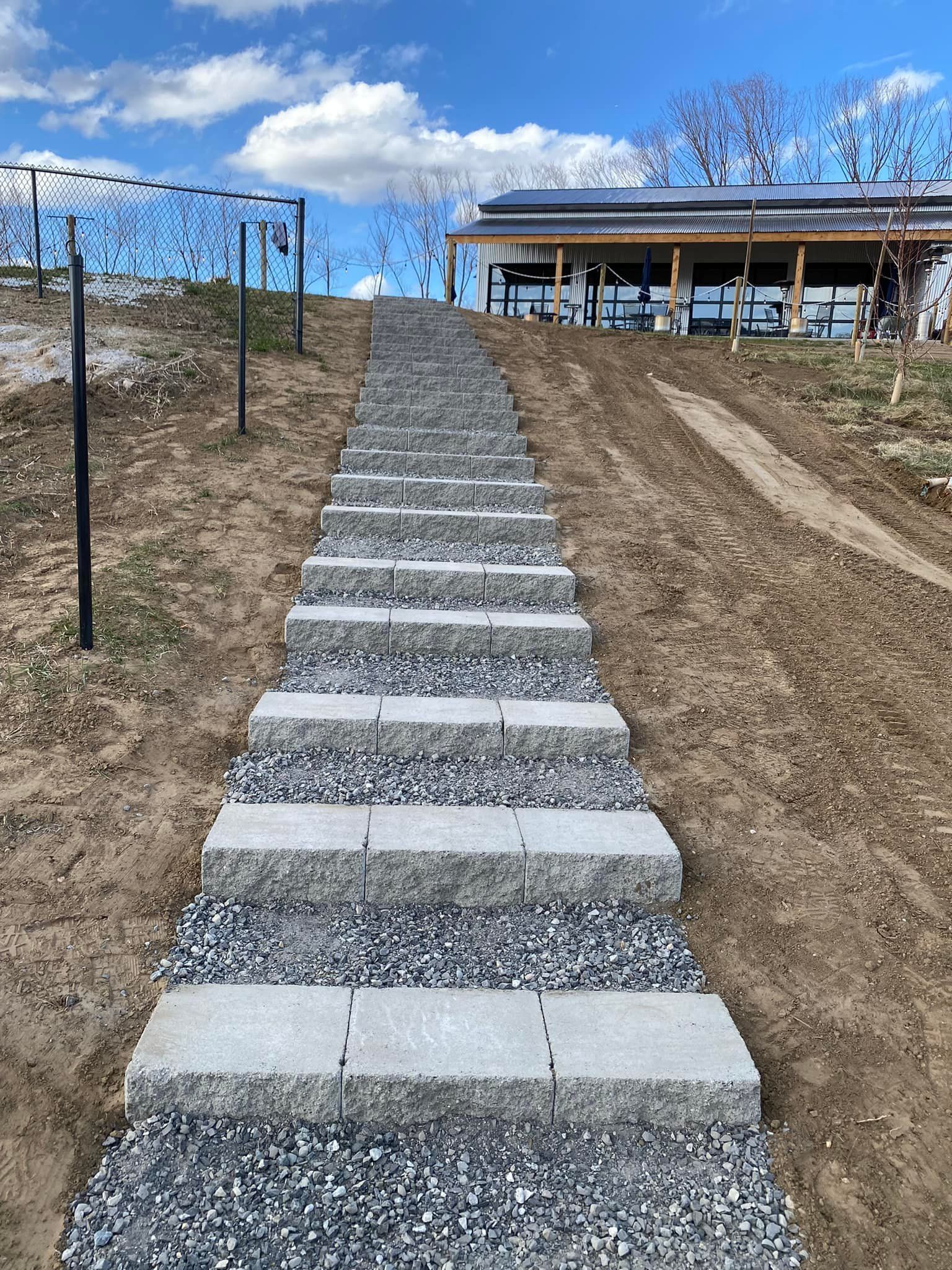 A row of stairs leading up to a house on a hill.