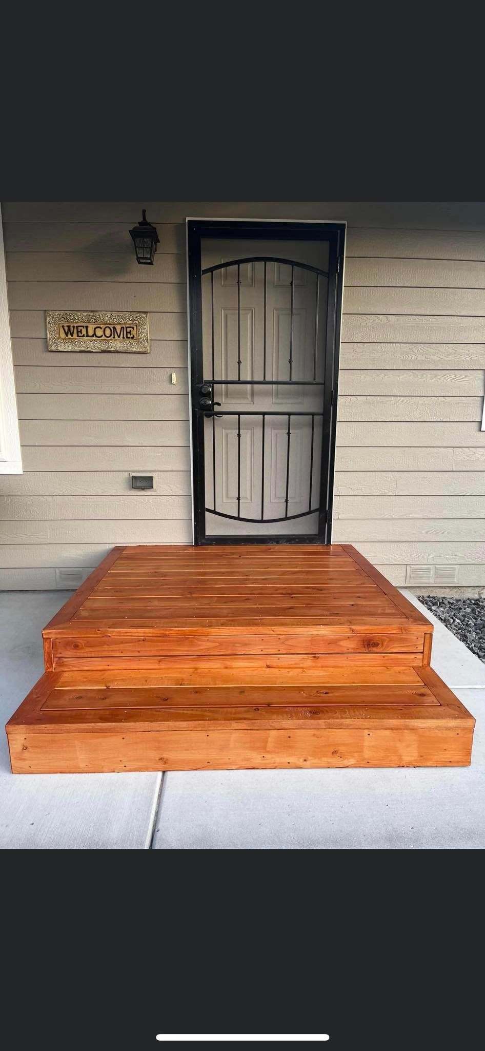 The front door of a house with wooden steps leading up to it.