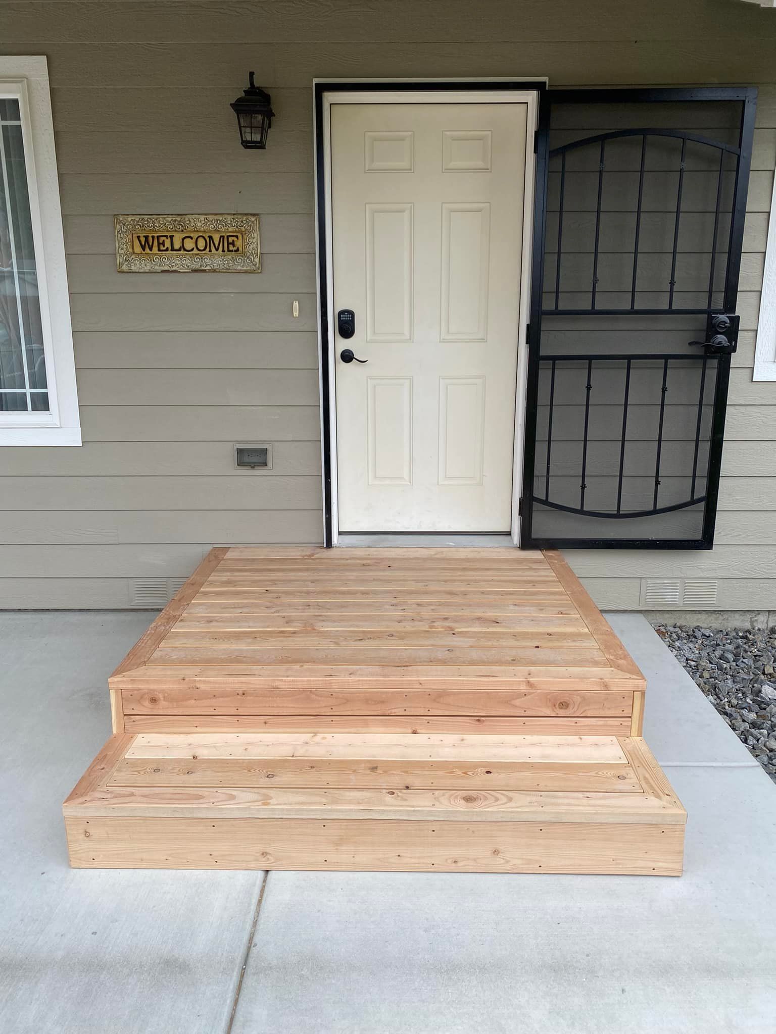 The front door of a house with a wooden ramp leading to it