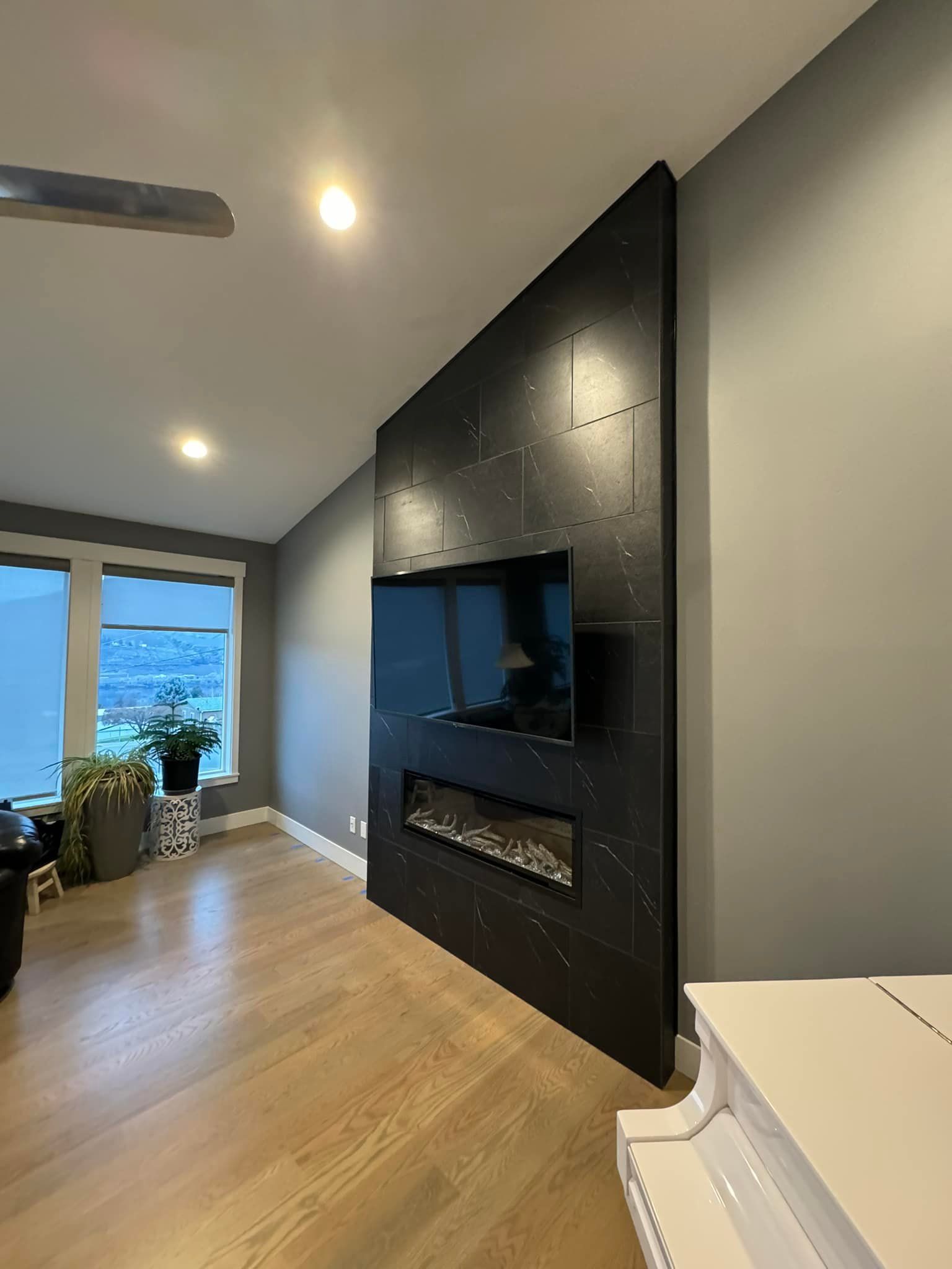 A living room with a fireplace and a flat screen tv.