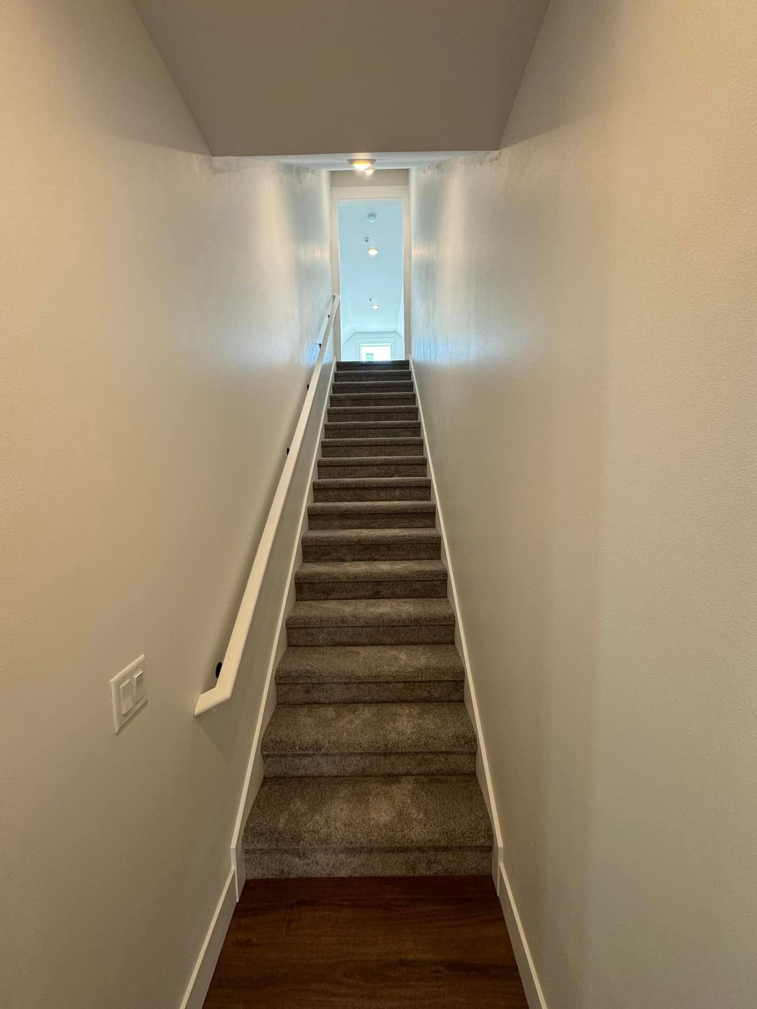 A set of stairs leading up to the second floor of a house.